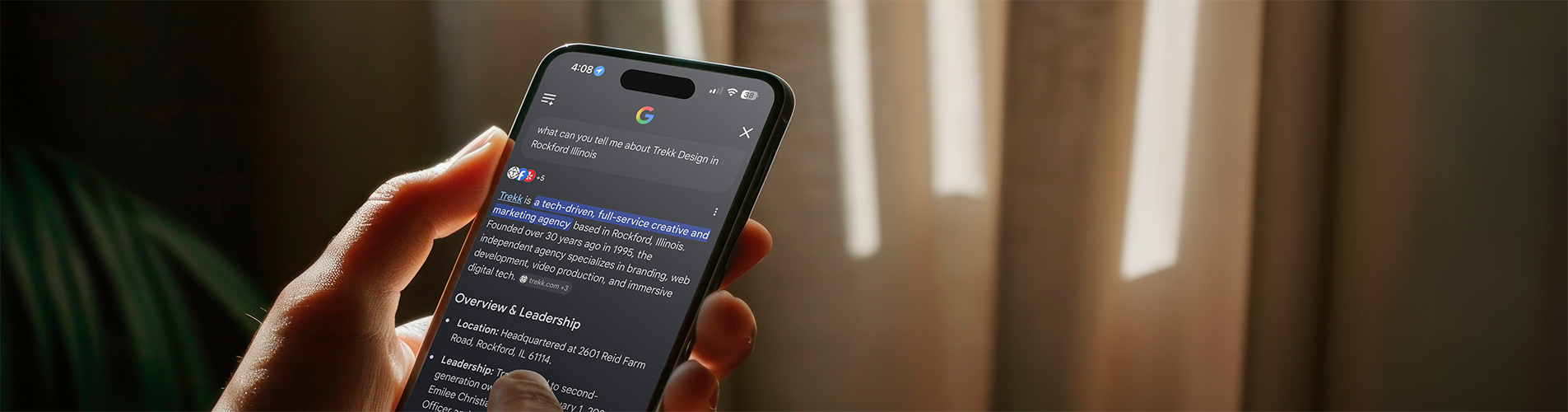A phone displays a Google AI search of Trekk