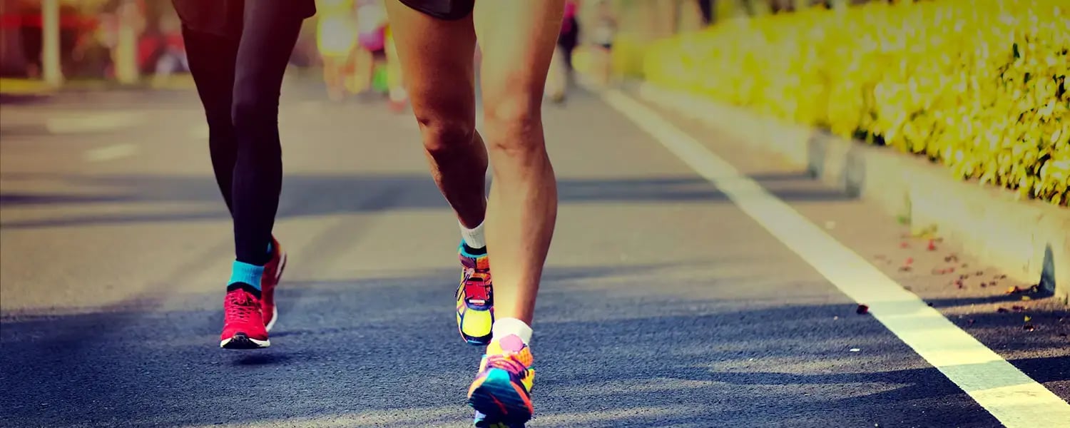 Two people jogging side by side