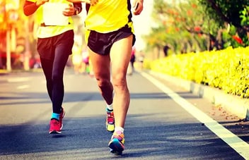 Two people jogging side by side