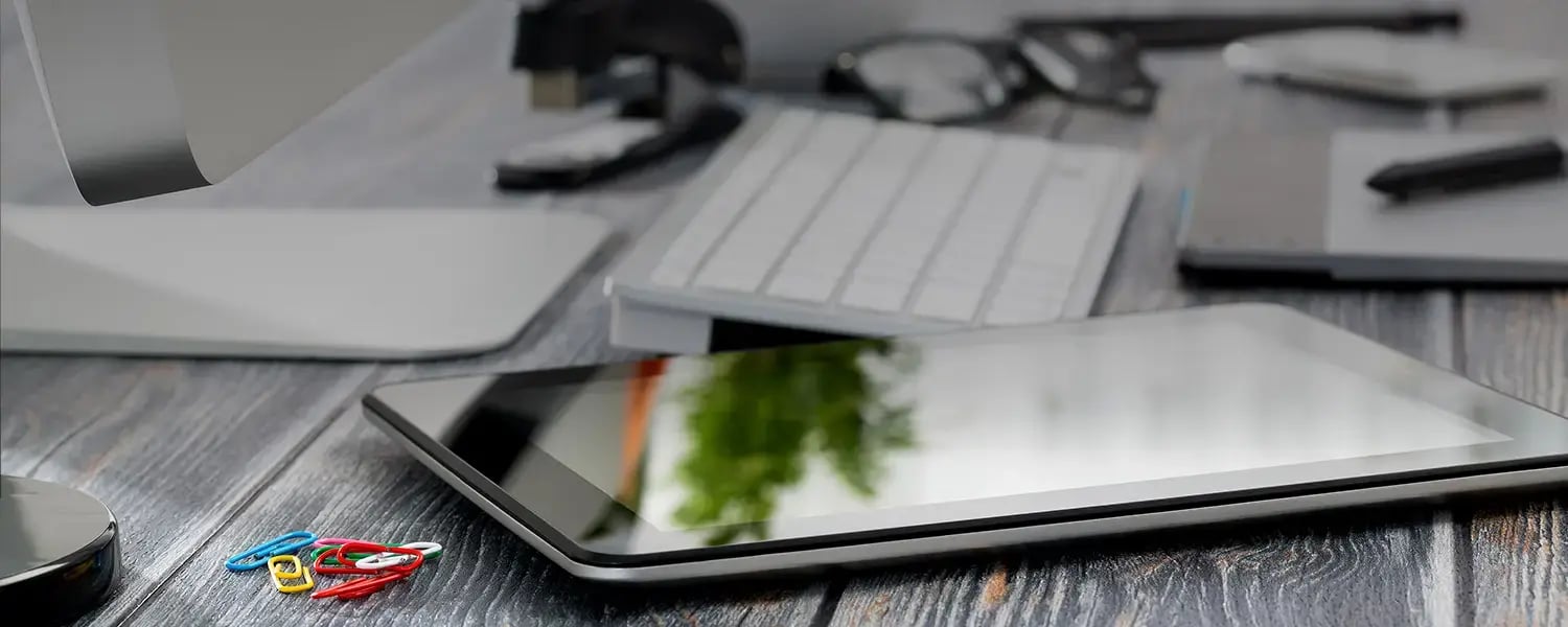 Paper clips and an iPad on a desk