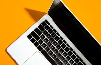 Laptop on orange background 