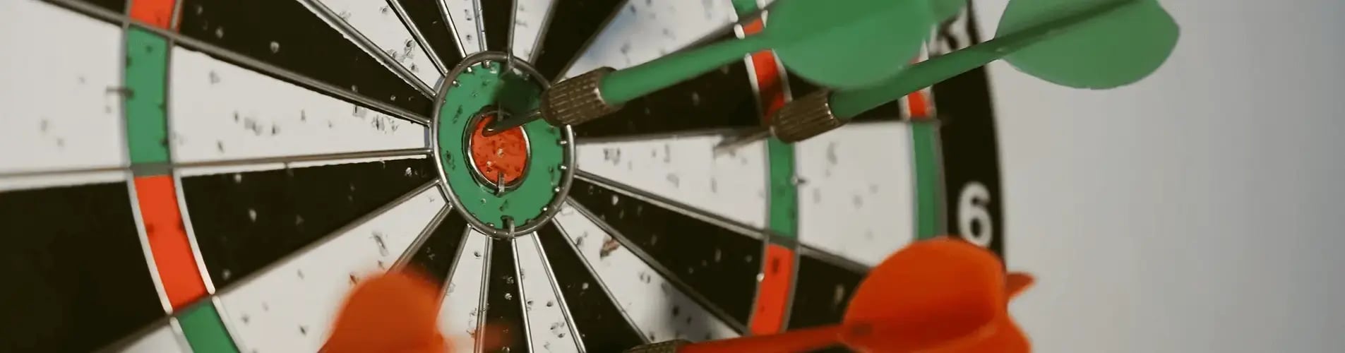 Darts stuck into a dartboard 