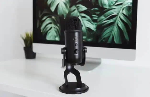 Podcast microphone in front of a computer