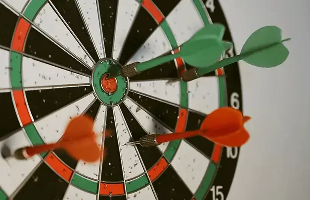 Darts stuck into a dartboard 