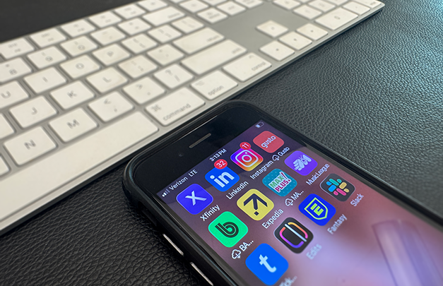 cell phone screen of social media and work-related apps